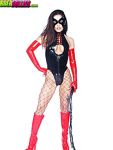 Masked Dominatrix In Black And Red Latex With Whip