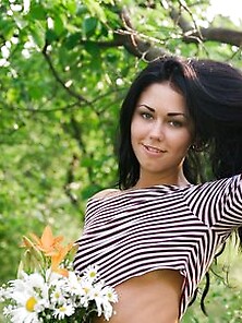 Raven-Haired Hussy With A Bunch Of Flowers Demonstrates Her Puss