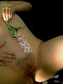 Busty Rave Girl Spreads Nude With Flower Petals
